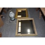 Two contemporary wall mirrors The first wall mirror within a carved in high relief gilt frame (
