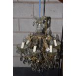 A late 19th / early 20th Century glass chandelier The seven branch gilt metal chandelier extending