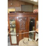 A late Victorian walnut wardrobe Having a cavetto cornice above a central panelled door flanked by