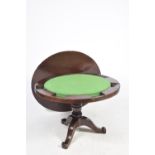 A mid 19th Century mahogany games table The circular table with a central baize lined gaming surface