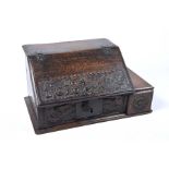 A rare 17th Century oak Bible box of small proportions The rectangular hinged front carved with