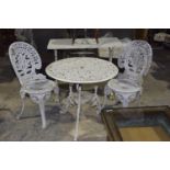 A painted metal three piece patio set Having a circular openwork table along with two patio chairs