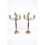 A pair of Louis XVI style candelabra The pair of brass candelabra with triform base extending to a