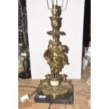 A gilt metal figural table lamp, 20th Century The figural lamp modeled with a cherub upon an