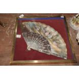 A framed mother of pearl fan The fan of typical form with 16 blades. The fan depicting ladies in