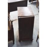 A pair of Victorian stained pine pedestal cupboards Each with a single panel door enclosing a single