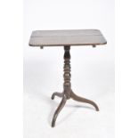 A Georgian oak tripod table The rectangular table top with rounded corners supported on a ring