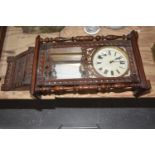 A late 19th early 20th Century "Anglo American" wall clock Having a walnut case with turned