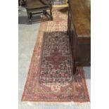 A Persian style runner The runner in ochre and red ground with geometric boarders, with central