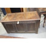 A 17th/18th Century oak coffer The rectangular three panel top above a carved frieze and three