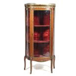 An attractive late 19th Century French rouge marble and Kingswood vitrine The bow front rouge marble