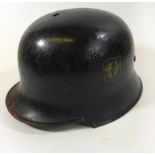 A German Luftshutz helmet, mid 20th Century With brown leather liner, black painted shell, with