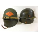 Two United States of America green painted military helmets, mid 20th Century Each with inner shell,