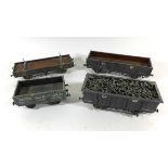 Four unboxed good quality 'O' gauge open wagons Including a timber wagon, all in Great Western