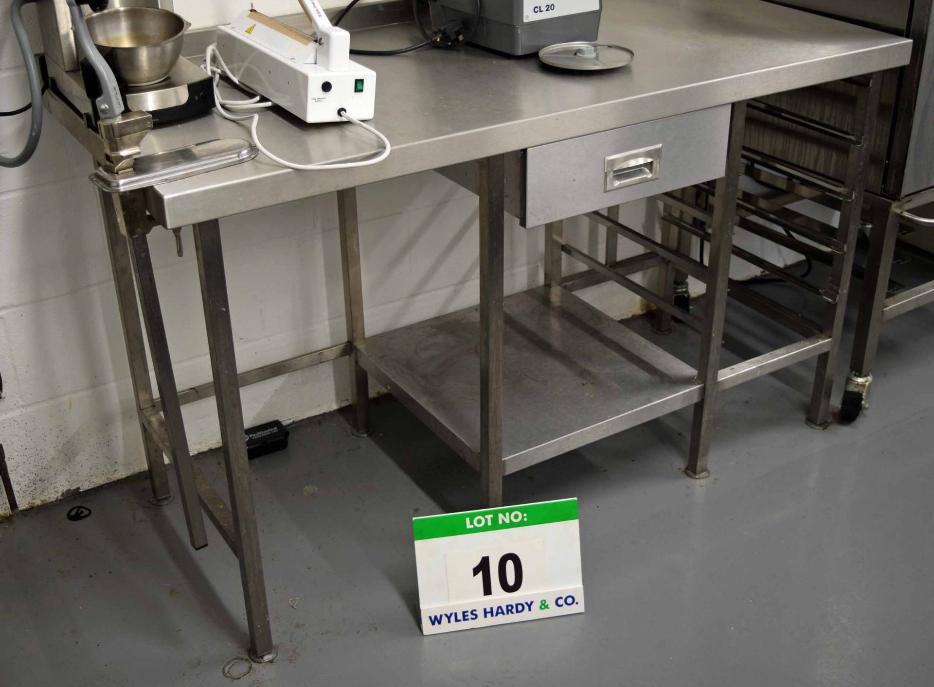 A 1500mm x 680mm Stainless Steel Preparation Table with Rack Shelves to One Side and Single Drawer