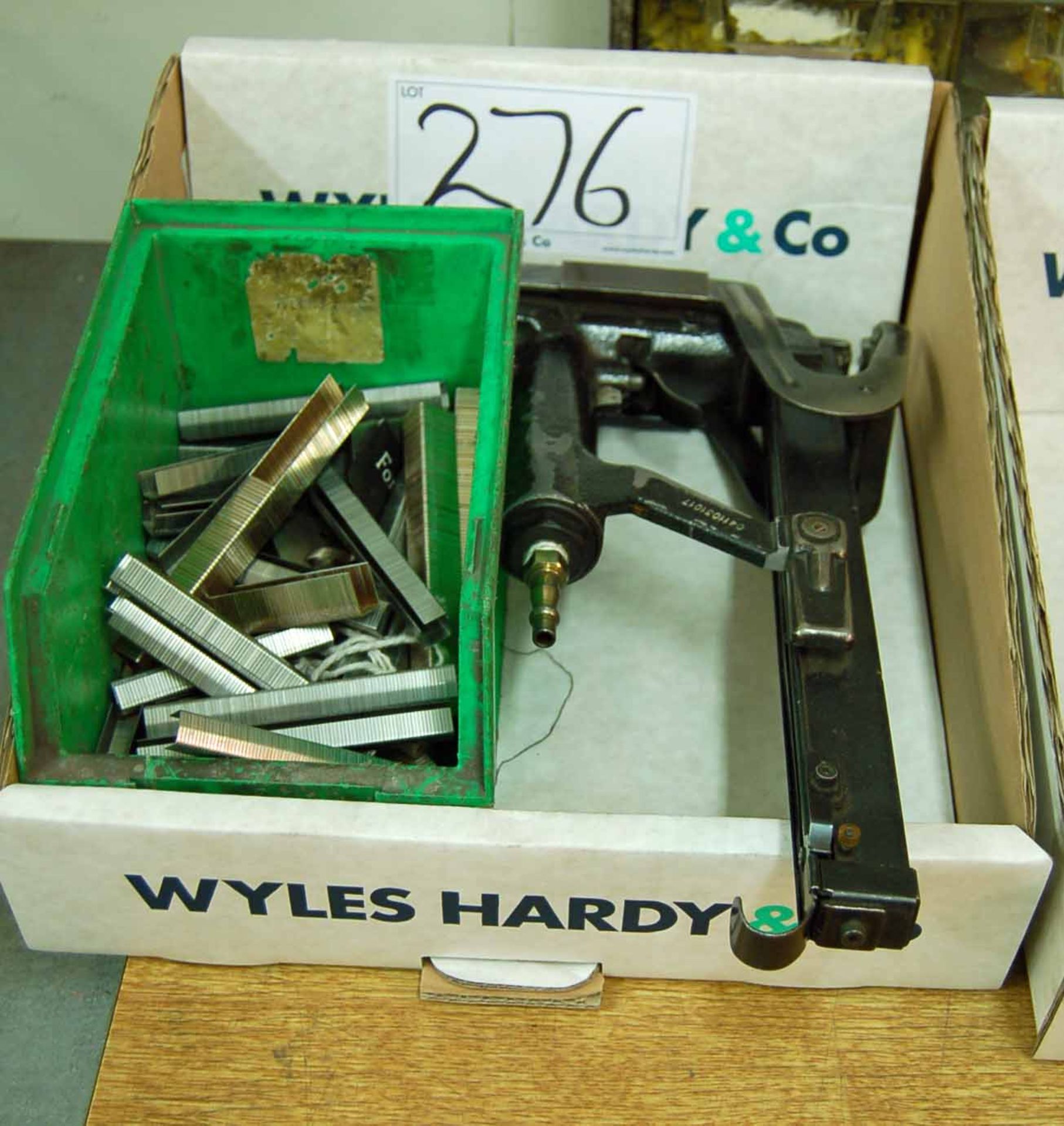 A STANLEY Long Mag Pneumatic Staple Gun and a Box of Staples