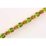 ARMBAND, 585/ooo Roségold, besetzt mit Peridots von ca. 38,12 ct. und Citrinen von ca. 8,61 ct., L