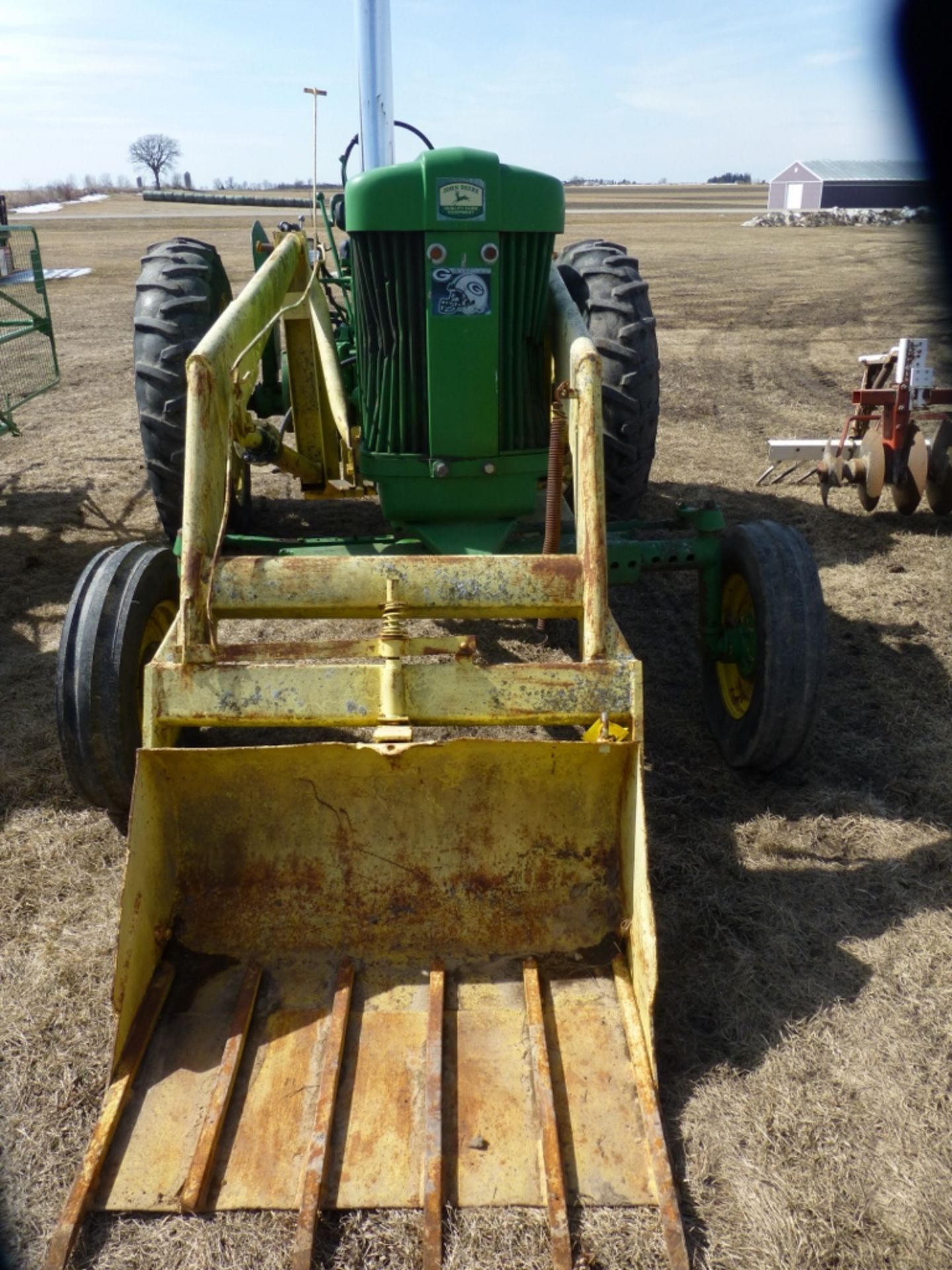 John Deere 60, w.f., gas engine, w/ loader. Missing pin on loader, 3-pt. tranny cover missing