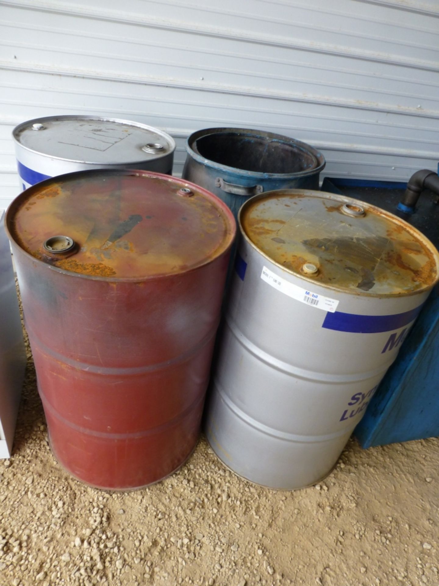 Used oil storage container with barrels