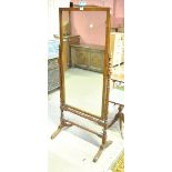 A late 19th century mahogany cheval mirror with rectangular plate held in ring turned and block