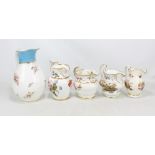 Five Coalport jugs, some decorated with floral sprays, one with floral sprays and a rural landscape,