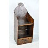 A George III oak hanging shelf with unusual arched side decoration,