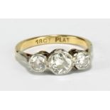 A yellow and white metal three white stone ring stamped '18ct Plat' to inner band, size J 1/2,