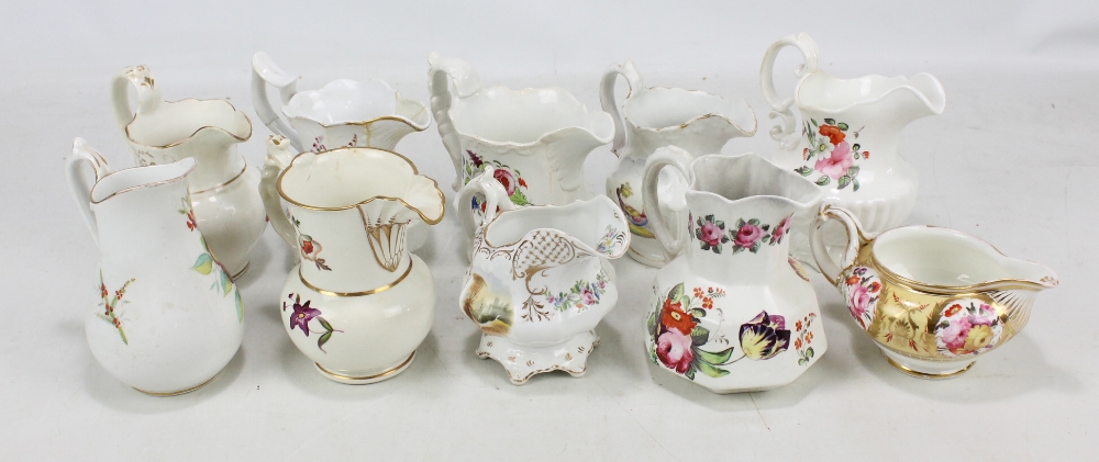 Ten Coalport floral painted jugs of various sizes, largest height 16cm (10).