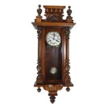 A circa 1900 stained beech and walnut spring driven Vienna style wall clock, length approx 90cm.