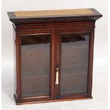 A mahogany two door glazed hanging cabinet with moulded cornice, height 71cm, width 70cm, depth 21.