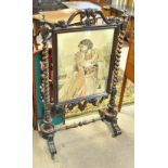 A Victorian rosewood fire screen with central woolwork panel in elaborate detailed frame,