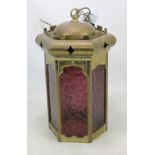 A hexagonal brass hall lantern with purple glass panels, height excluding fitment 42cm.