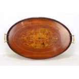 An Edwardian mahogany and inlaid twin handled tray of oval form with shaped gallery, length 61.5cm.