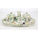 A large Coalport floral encrusted inkstandish with central candlestick flanked by twin lidded pots,