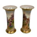 A small pair of Royal Worcester waisted vases with painted cottage decoration signed by Rushton,