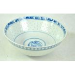 A late 19th/early 20th century Chinese blue and white rice work decorated bowl with four character