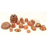 A group of small and very small copper jelly moulds,