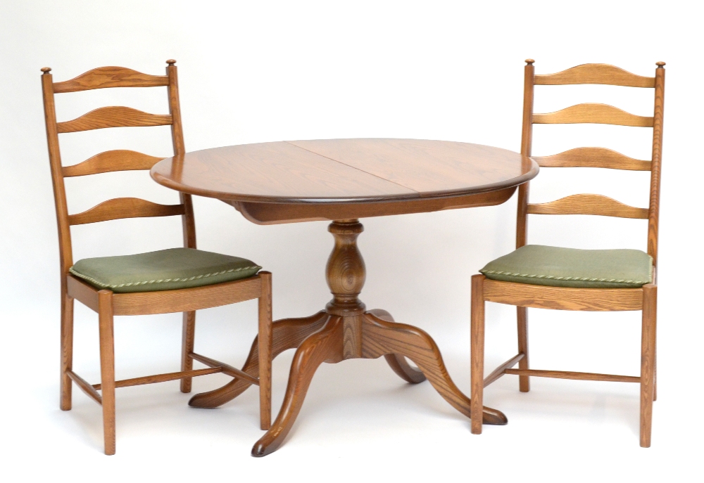 ERCOL; an extending dining table, length when extended 148cm,