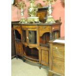 An Edwardian rosewood and inlaid chiffonier with shaped back above bowfronted central section with