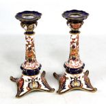 A pair of Royal Crown Derby 'Old Imari' pattern candlesticks with fluted tapering stems and