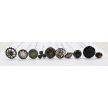 Ten various predominantly early 20th century hat pins to include a white metal framed green