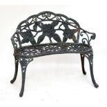 A small floral motif cast iron garden bench, width 102.5cm.