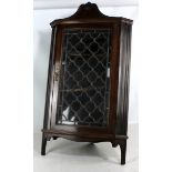 A mahogany corner cupboard with glazed door enclosing two shelves, width 51cm.