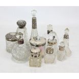 Nine variously hallmarked silver collared clear glass scent bottles to include a tapering example,