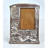 An early 20th century silver plated photo frame embossed with 'Seesaw, Majorie Daw' scene,