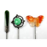 Three hardstone hat pins comprising an apple green jade coloured stone hallmarked silver framed