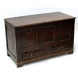 An oak blanket box with three panel front above two drawers, approx 72 x 119 x 55cm.