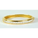 BOODLES; an 18ct yellow gold and diamond set hinged bangle,