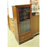An early 20th century oak music cabinet with glazed door above single drawer, height 118cm,