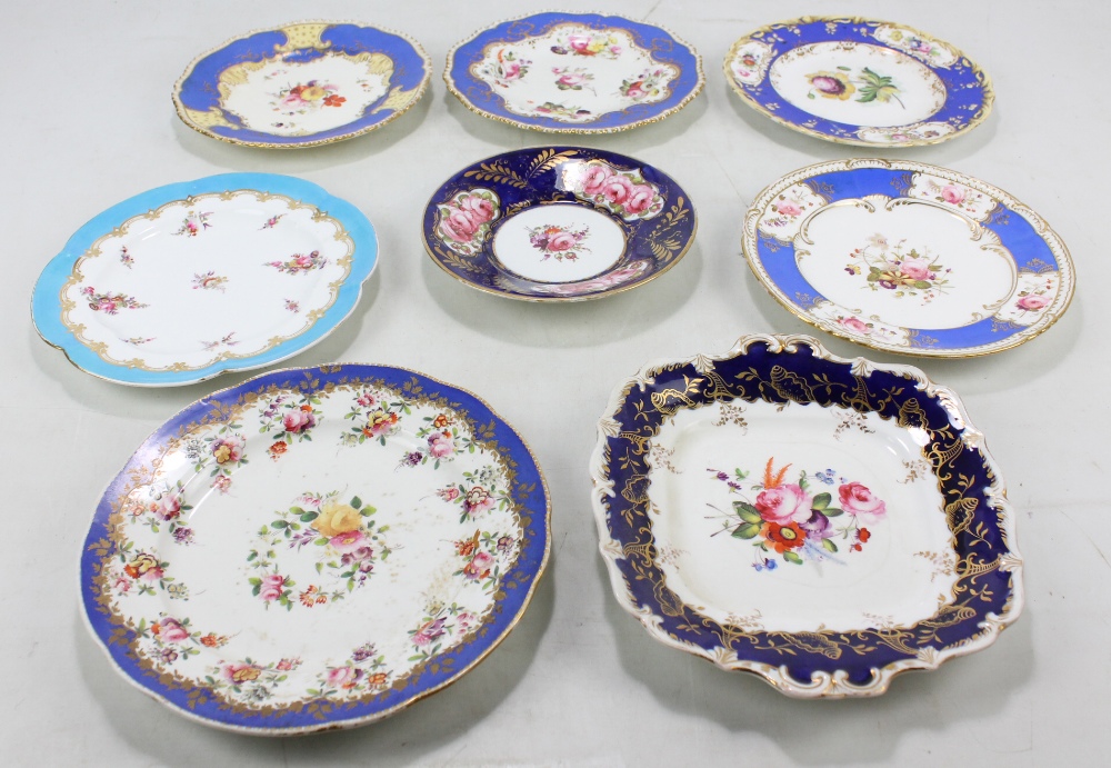 Eight Coalport floral decorated gilt heightened cabinet plates and dishes with blue borders,